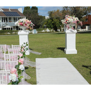 Large Pillars with light pink or white flower vase.